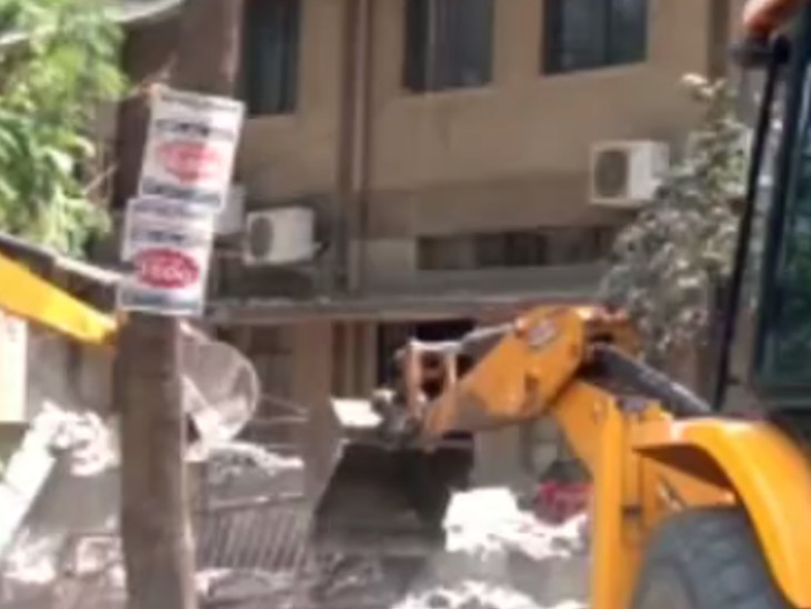 Luggage, including vehicles crushed under the debris, is being removed.