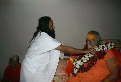 This picture is from 2016.  Sri Sri Ravishankar, the founder of Art of Living, doing Paduka Pujan of Shankaracharyaji.