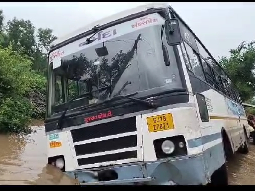 ST bus stuck in rain water between Vedach and Uber in Jambusar, bus