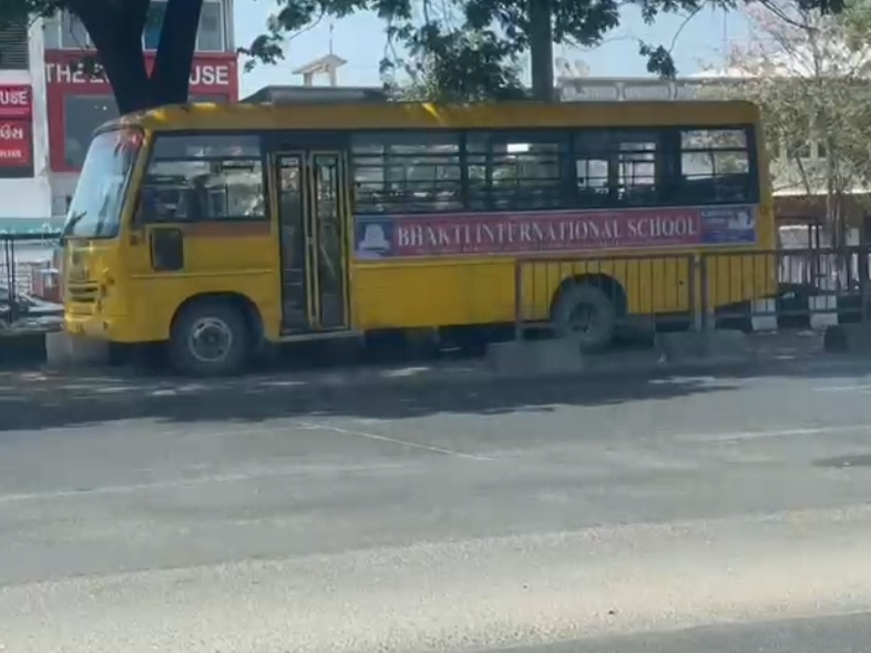 Bhakti International School bus parked in Nana Varachha BRTS corridor