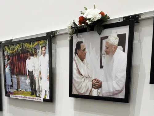 Family looking at Vijaybhai's photograph.