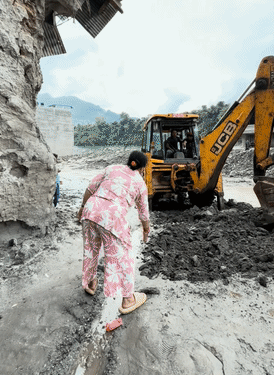 A strong stench is coming from the ground while clearing the road with a JCB.