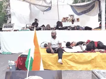 प्रदर्शनकारी स्टेज पर पोस्टर और झंडे के साथ मौजूद हैं। - Dainik Bhaskar