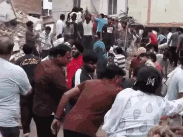 Locals rushed to the scene after the building collapsed, some using hammers to remove the debris. - Bhaskar English