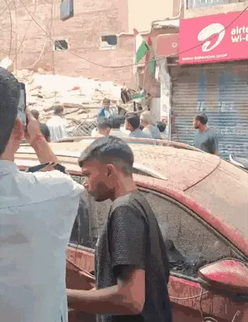 Some vehicles are also buried under the debris. Rescue teams are arriving at the scene after moving the vehicles aside. - Bhaskar English